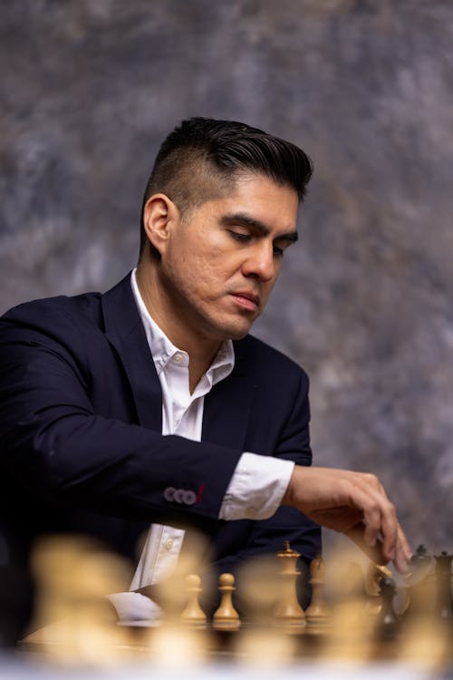 Brunette Man in Suit Playing Chess