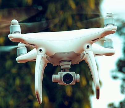 Close-up of a drone with a camera flying outdoors, showcasing modern technology.