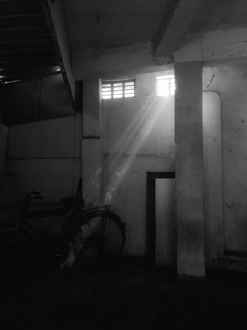 Free Light in an Abandoned Building in Black and White  Stock Photo