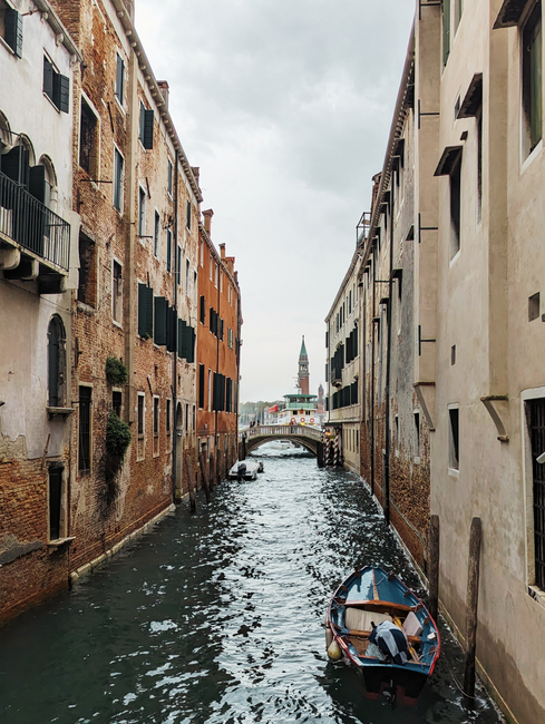 Charming Venetian canal with gondola and historic buildings in Venice, Italy.