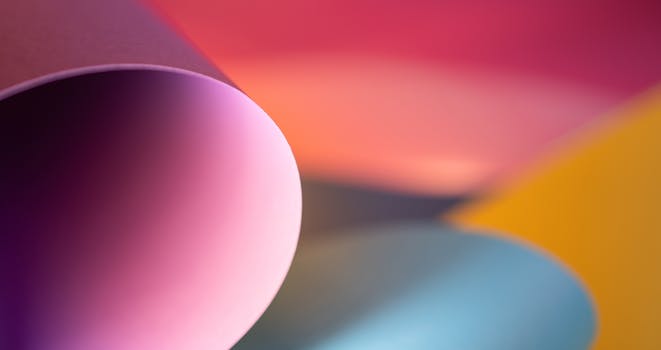 Colorful abstract image of rolled paper sheets in vibrant lighting.