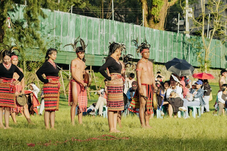 Performers In Traditional Indonesian Costumes In Front Of An Audience