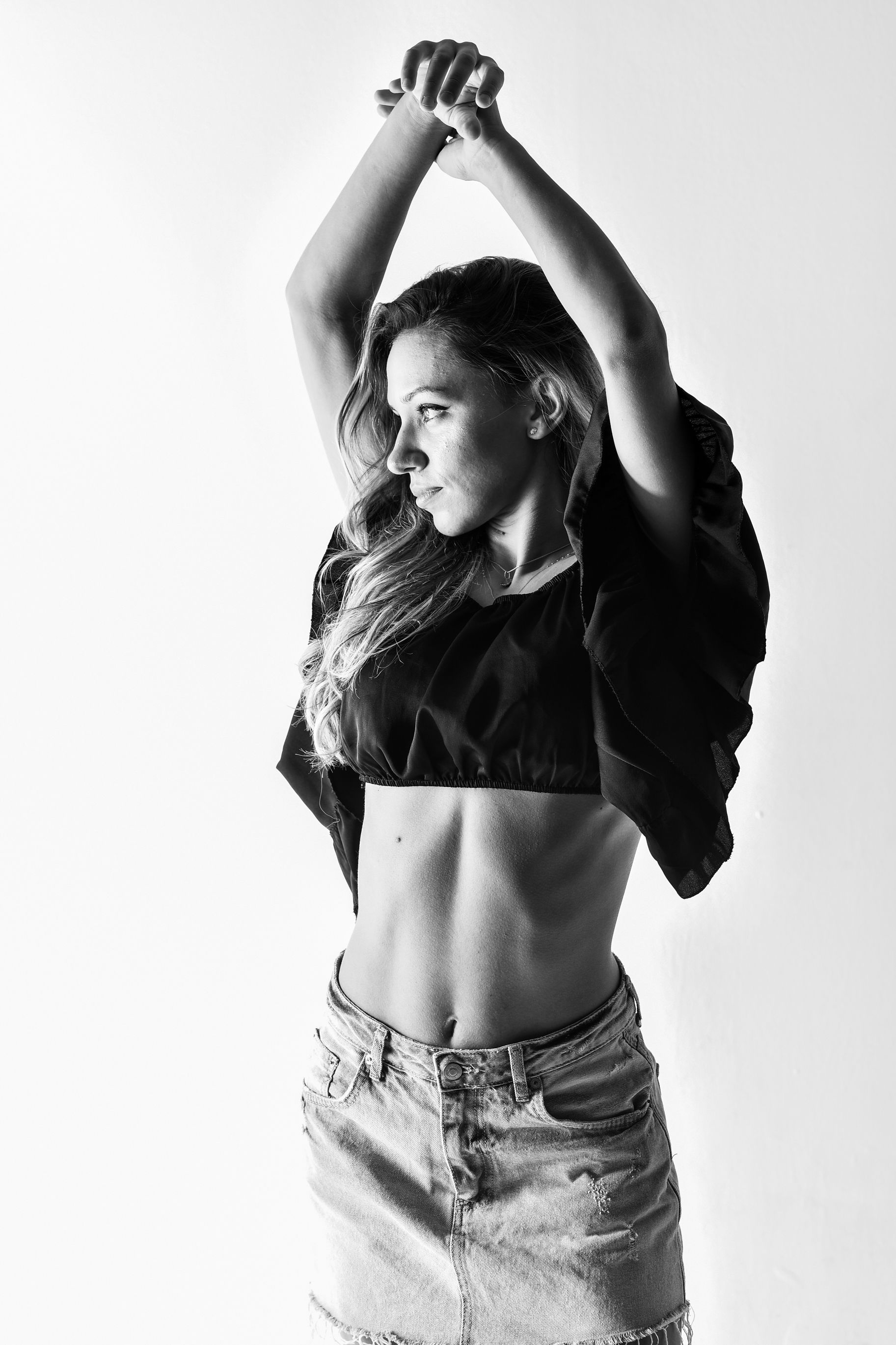 Model Posing with Arms Raised · Free Stock Photo