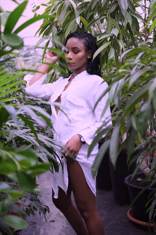 Woman Standing Beside Plants