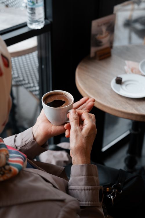 Free A person enjoys a warm cup of coffee indoors at an Istanbul café. Stock Photo