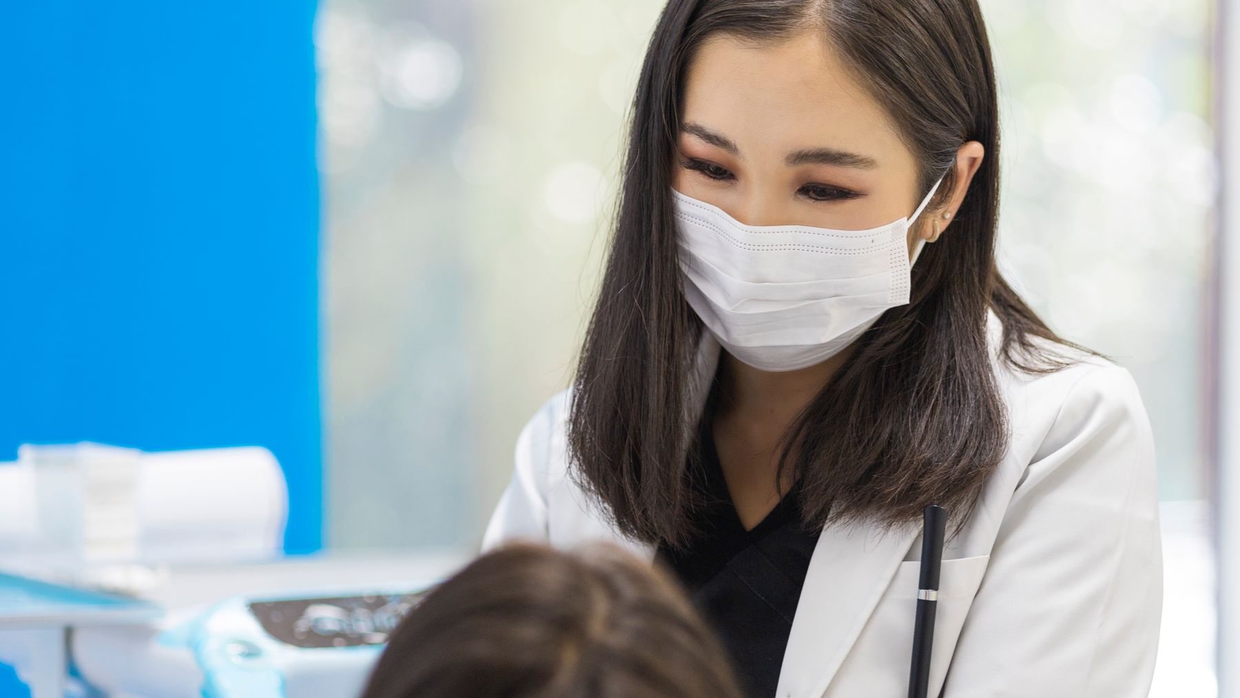 Smiling dental patient and clinician in a bright modern private dental clinic