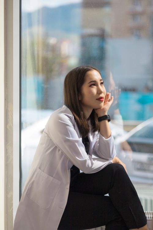 Young Woman Sitting by the Window · Free Stock Photo