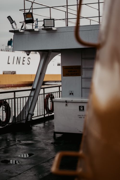 Free A moody view of a ferry deck in Istanbul with industrial elements and wet surfaces. Stock Photo