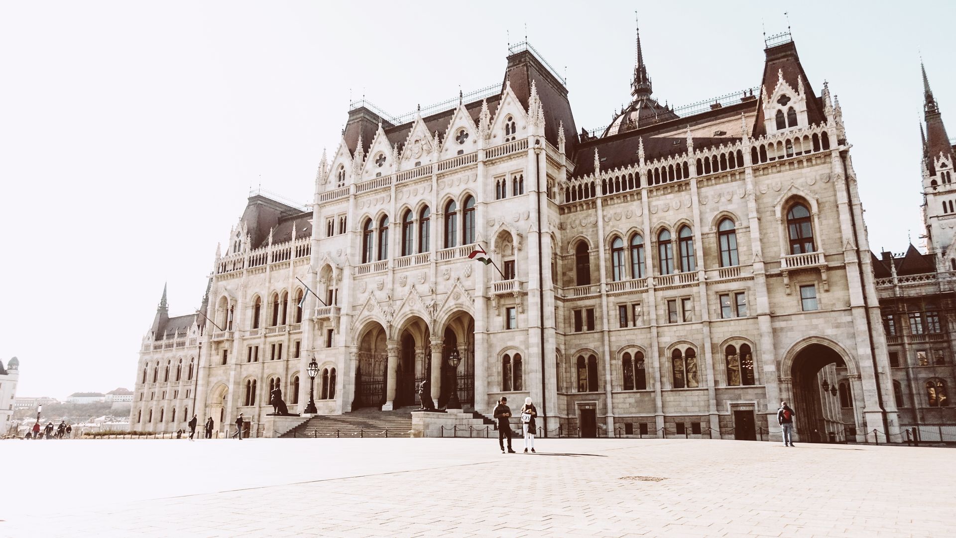 Passersby in Front of Hungarian Parliament Building in Budapest