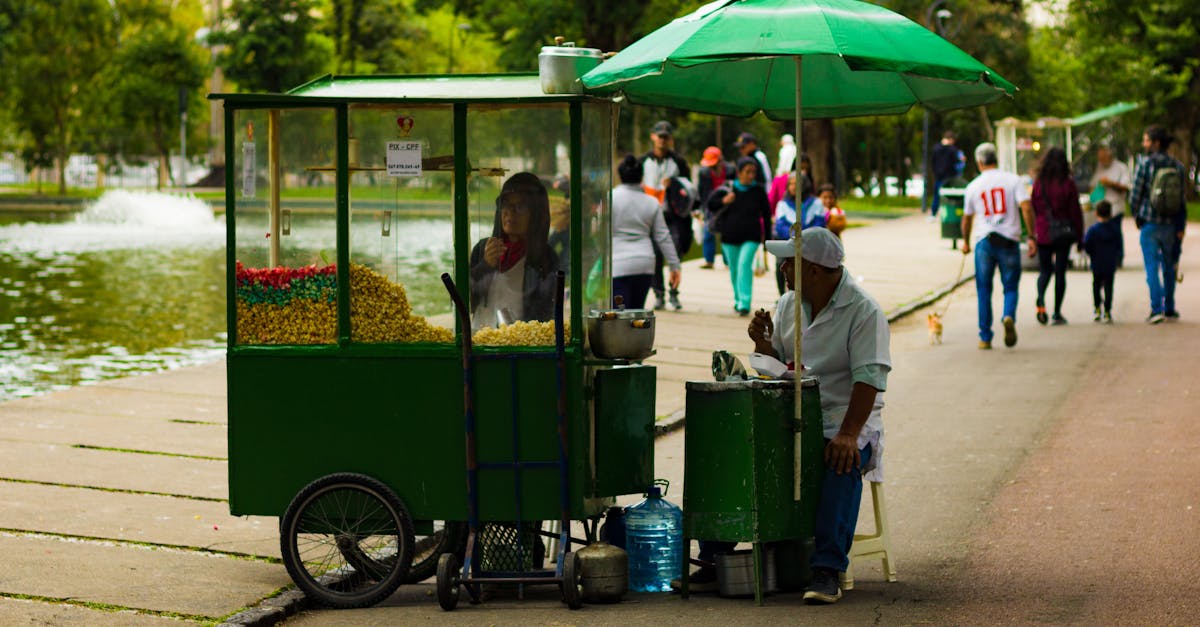 People Selling Snacks from a Food Cart in a Park · Free Stock Photo
