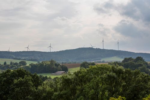 Free Idyllic rural landscape featuring wind turbines against a cloudy sky. Stock Photo
