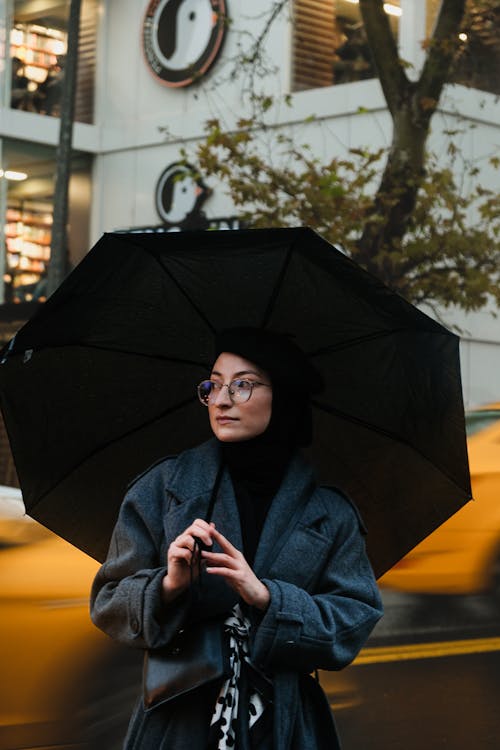 Woman in Hijab Standing with Umbrella