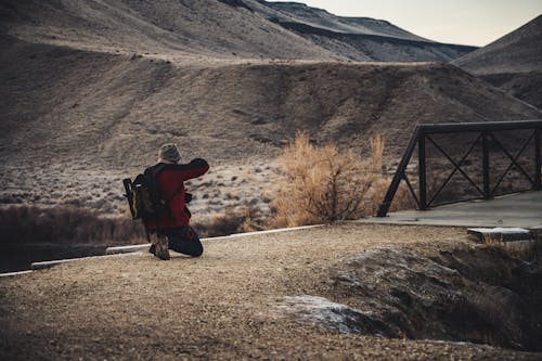 Man Wearing Red Jacket Taking Picture