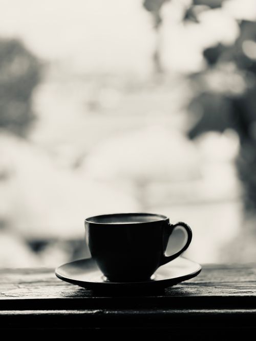 Free Black and white silhouette of a coffee cup on a saucer by a window in İstanbul. Stock Photo