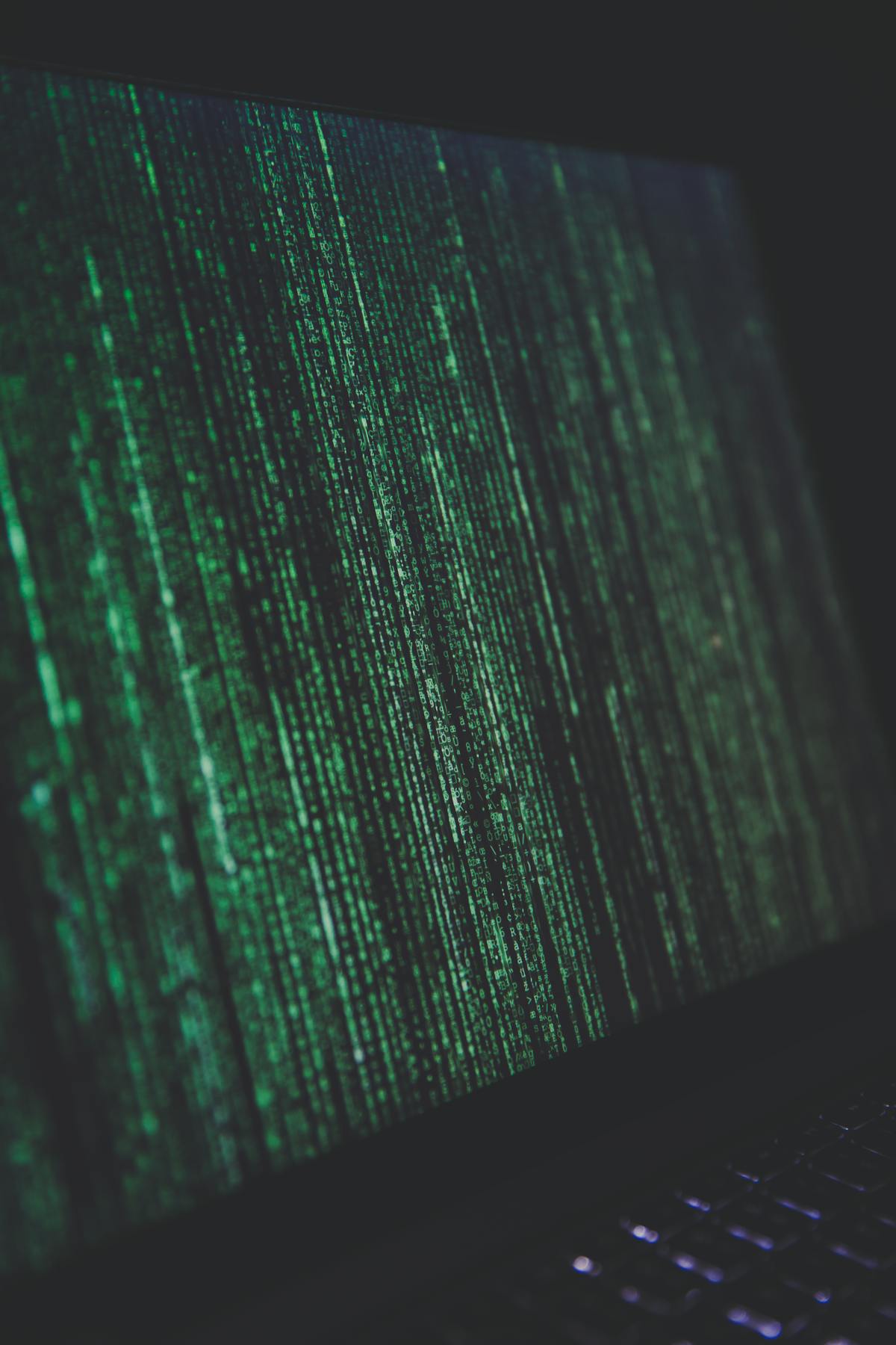 Person using a laptop with tools and components nearby, symbolizing repairable computing