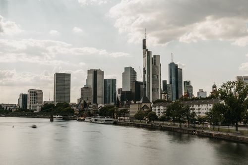 Free A scenic view of Frankfurt's skyscrapers along the Main River during the day. Stock Photo