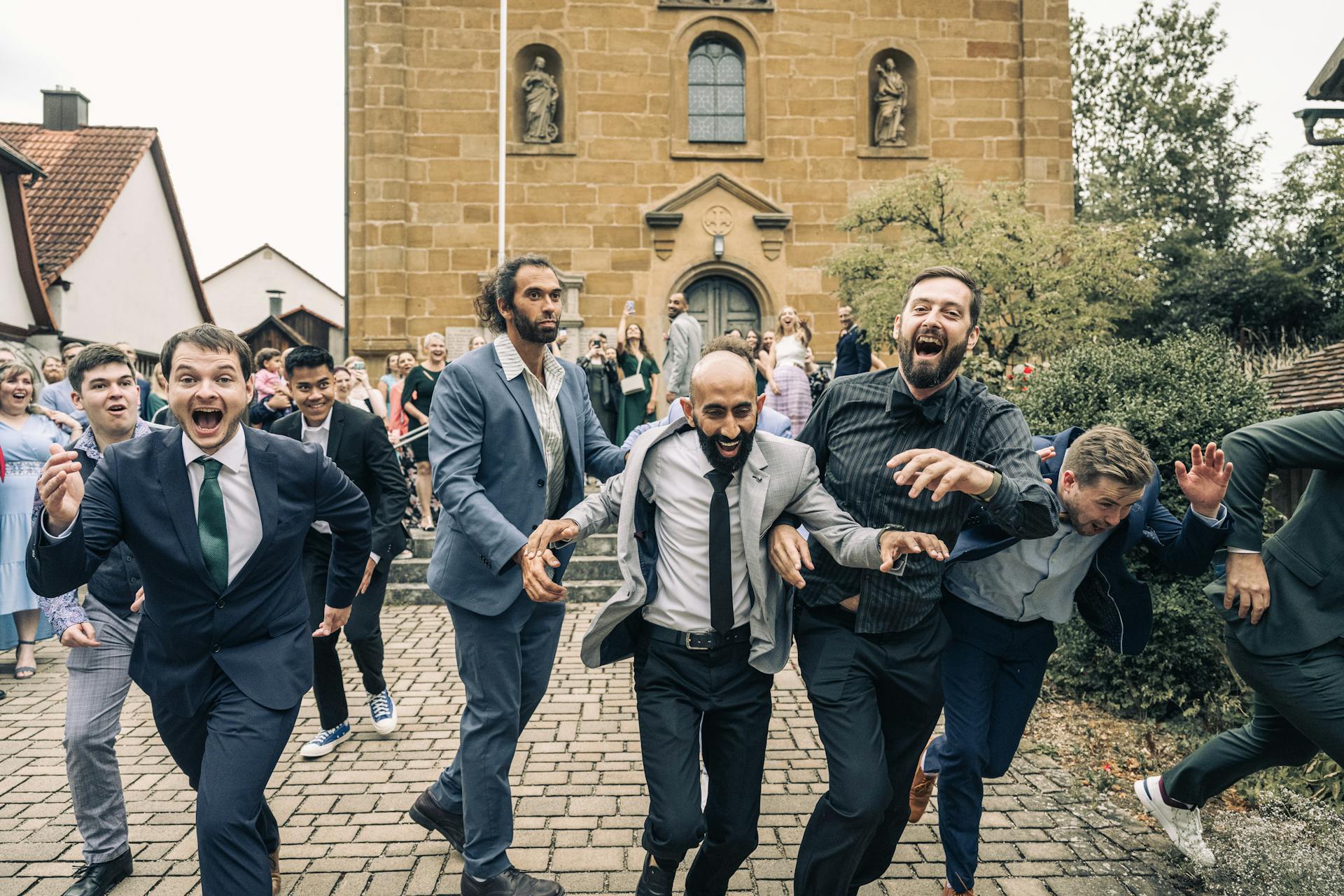 Group of Men in Suits Running in Celebration