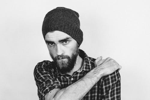 Free Man in Beanie Holding His Shoulder Stock Photo
