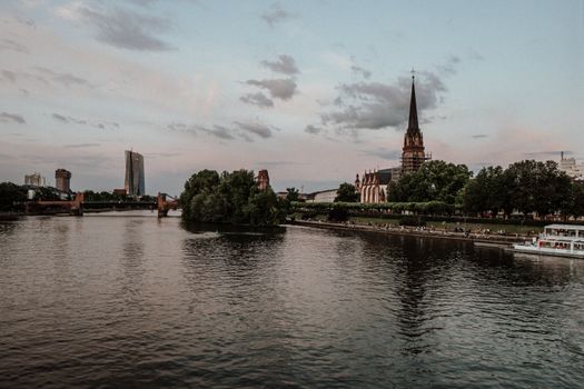 Beautiful evening view of Frankfurt featuring the river, cathedral, and urban skyline.