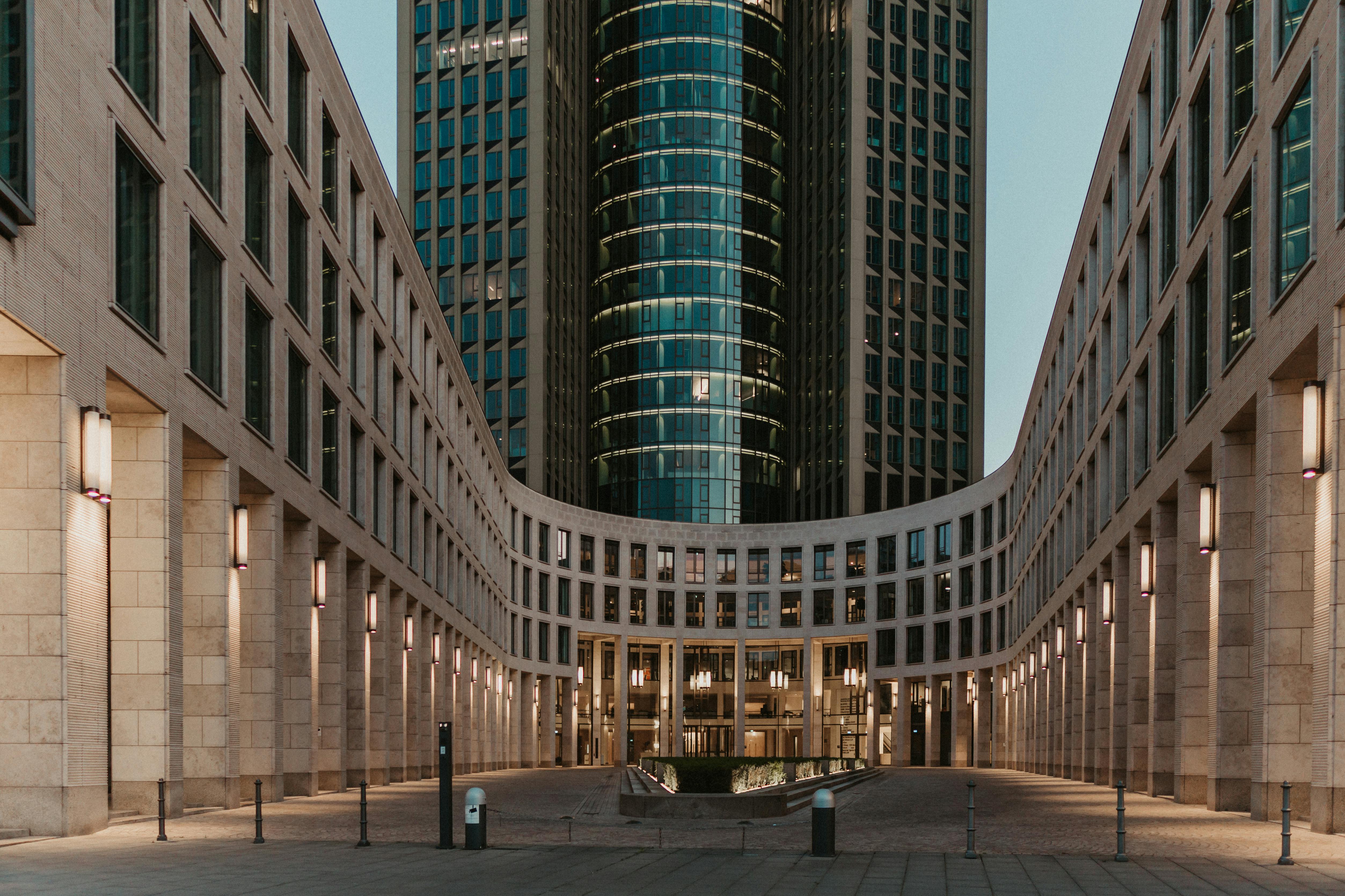 Experience the striking modern architecture of Frankfurt's Tower 185 at dusk.