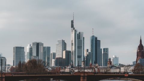 Explore the iconic skyline of Frankfurt featuring modern skyscrapers and historic landmarks over the Main River.