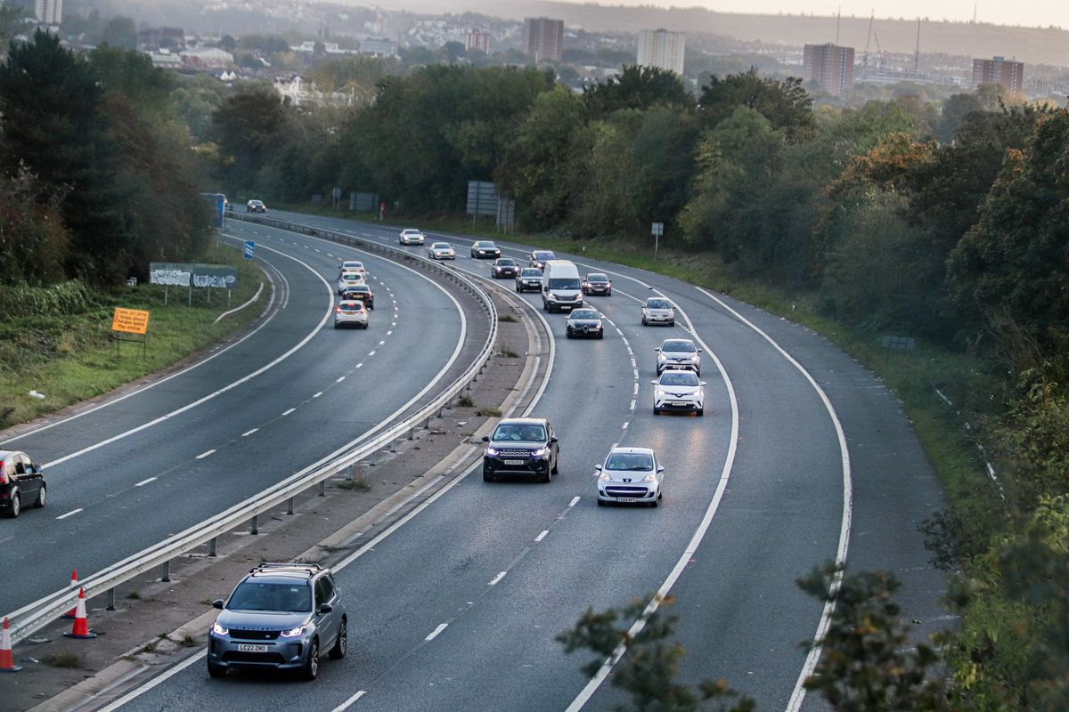 Cars on a motorway with the Bristol skyline in the background