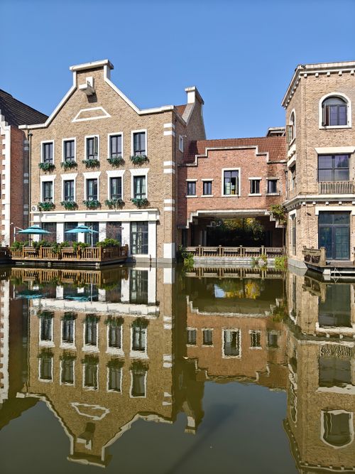 Free Beautiful reflection of waterfront European-style buildings in calm canal. Stock Photo