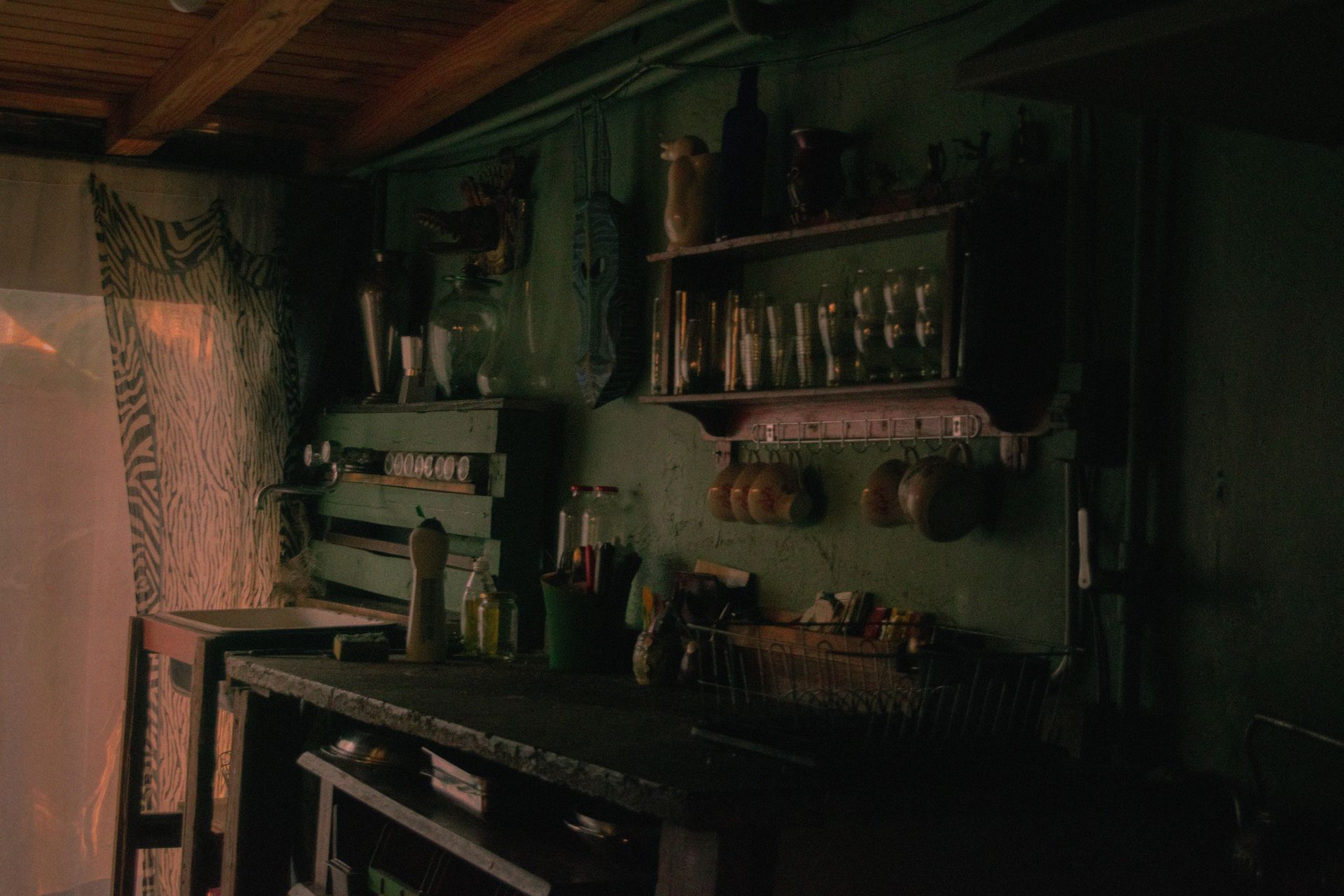 A nostalgic kitchen with vintage utensils and warm lighting, showcasing rustic charm.