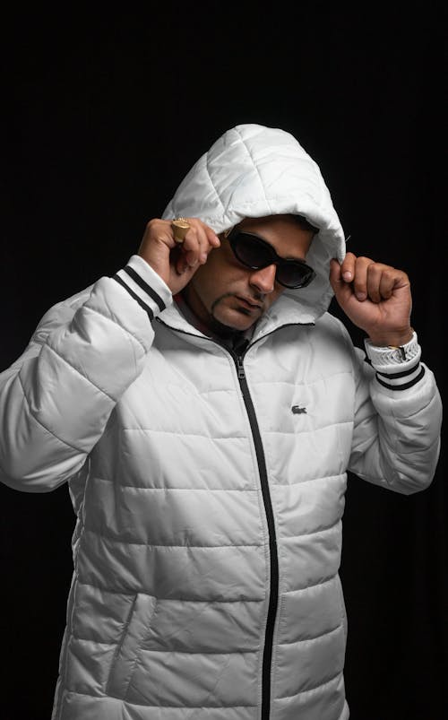 Man in White Warm Jacket Fixing Hood