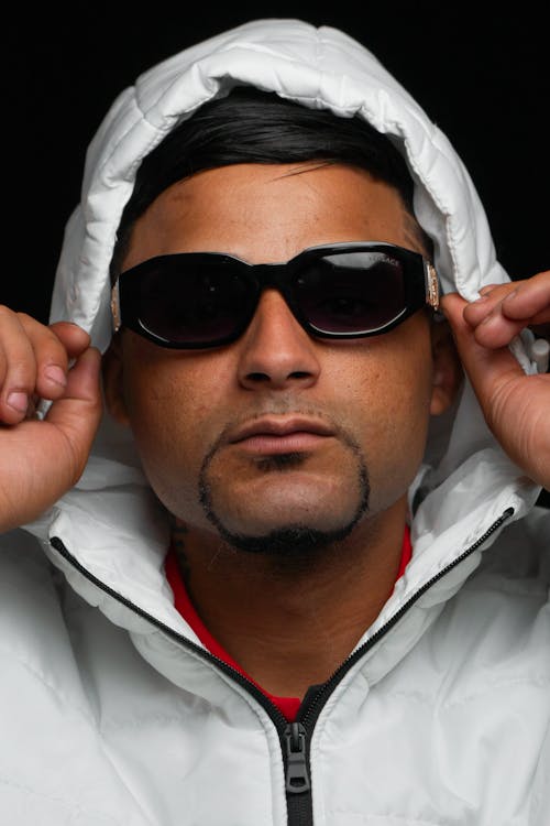 Portrait of Man in Sunglasses and White Hood