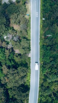 Drone shot of a truck driving through a forest road in Sarıyer, Istanbul.