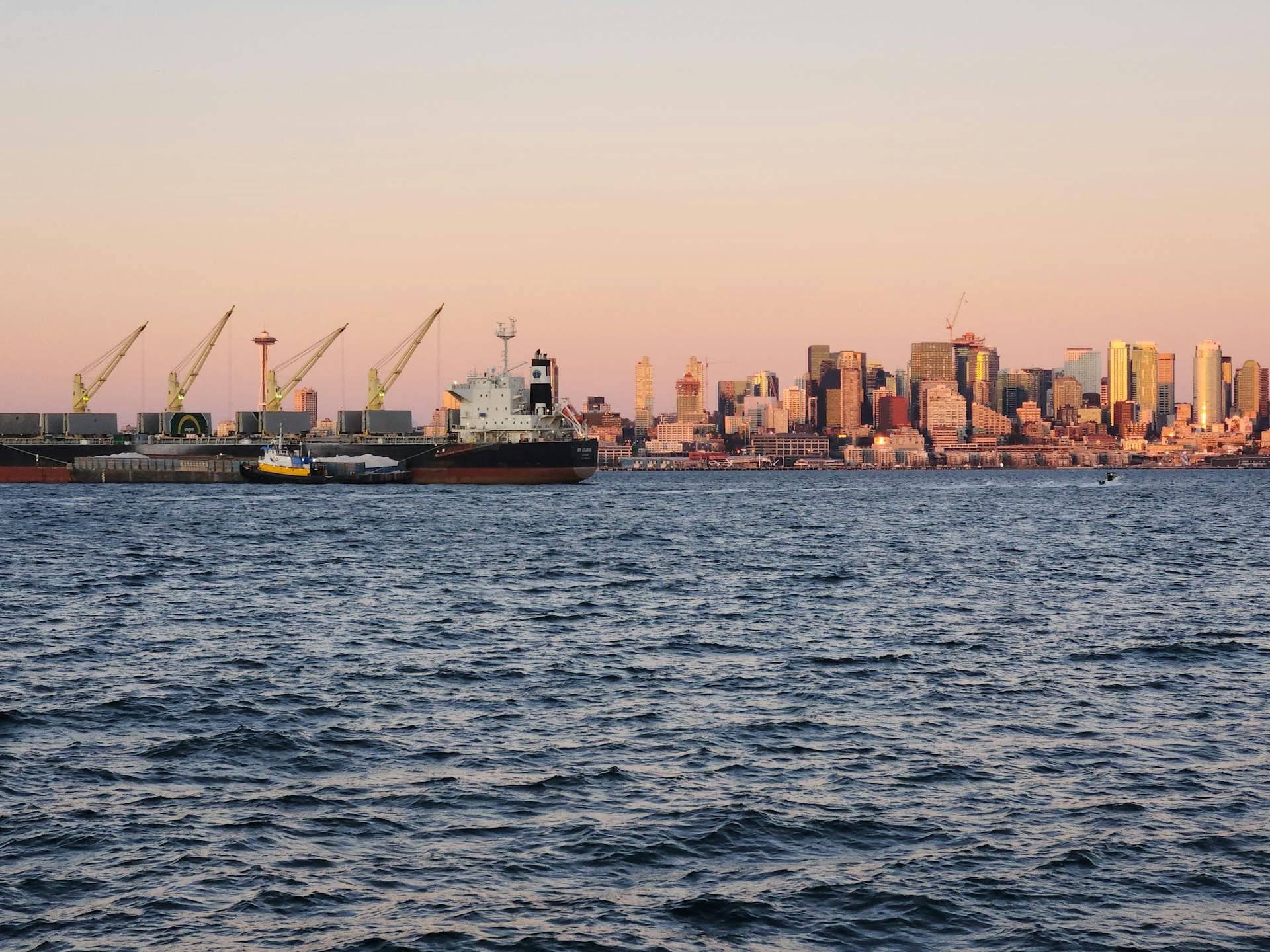 Boats in a Port and Modern Skyline at Sunset