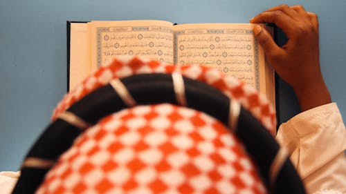 Top View of Man Reading Koran
