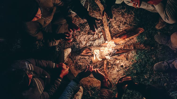 Men Surrounding Bonfire In Night