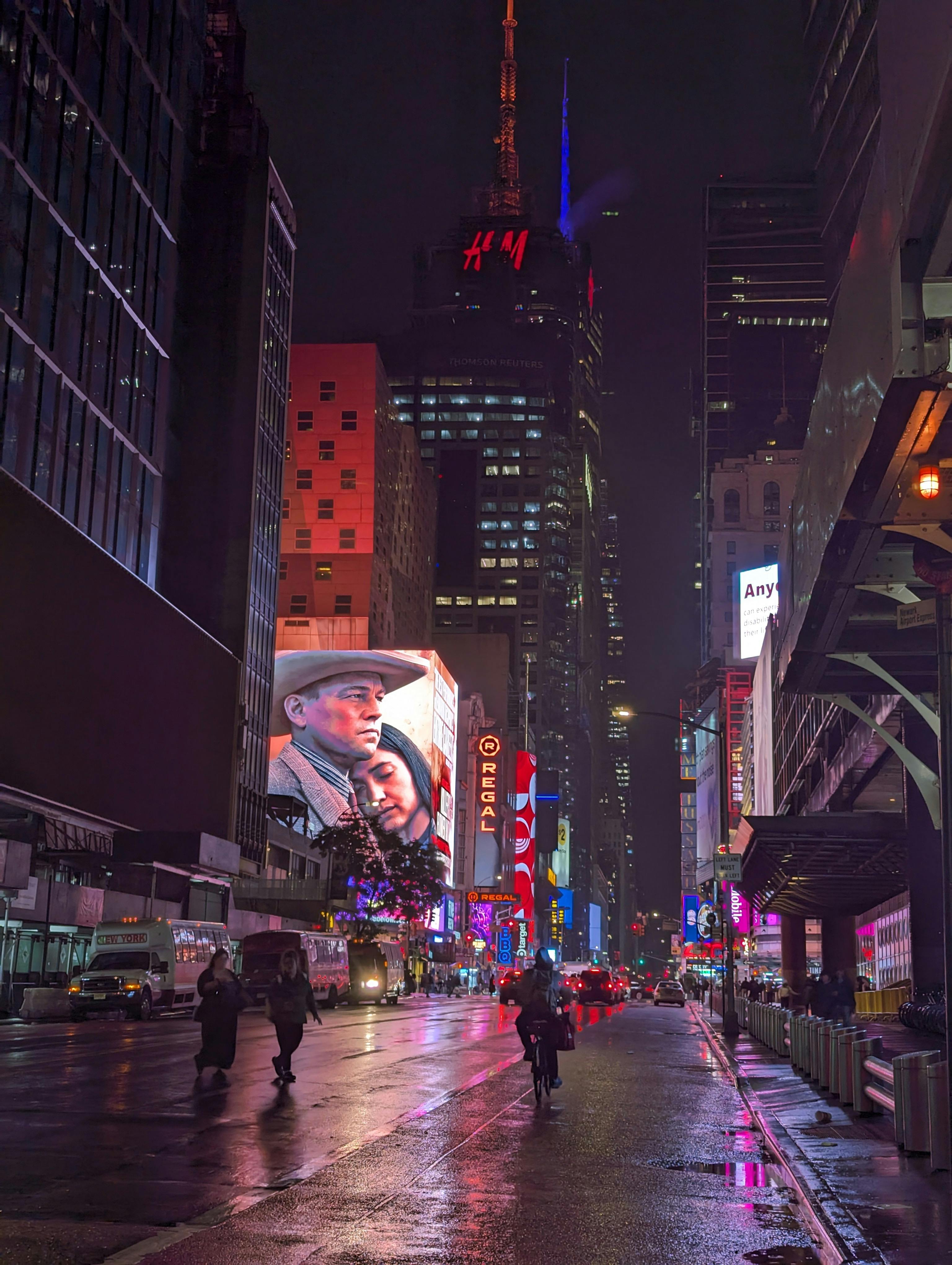 A vivid night scene capturing the illuminated billboards and bustling streets of Times Square, New York City.