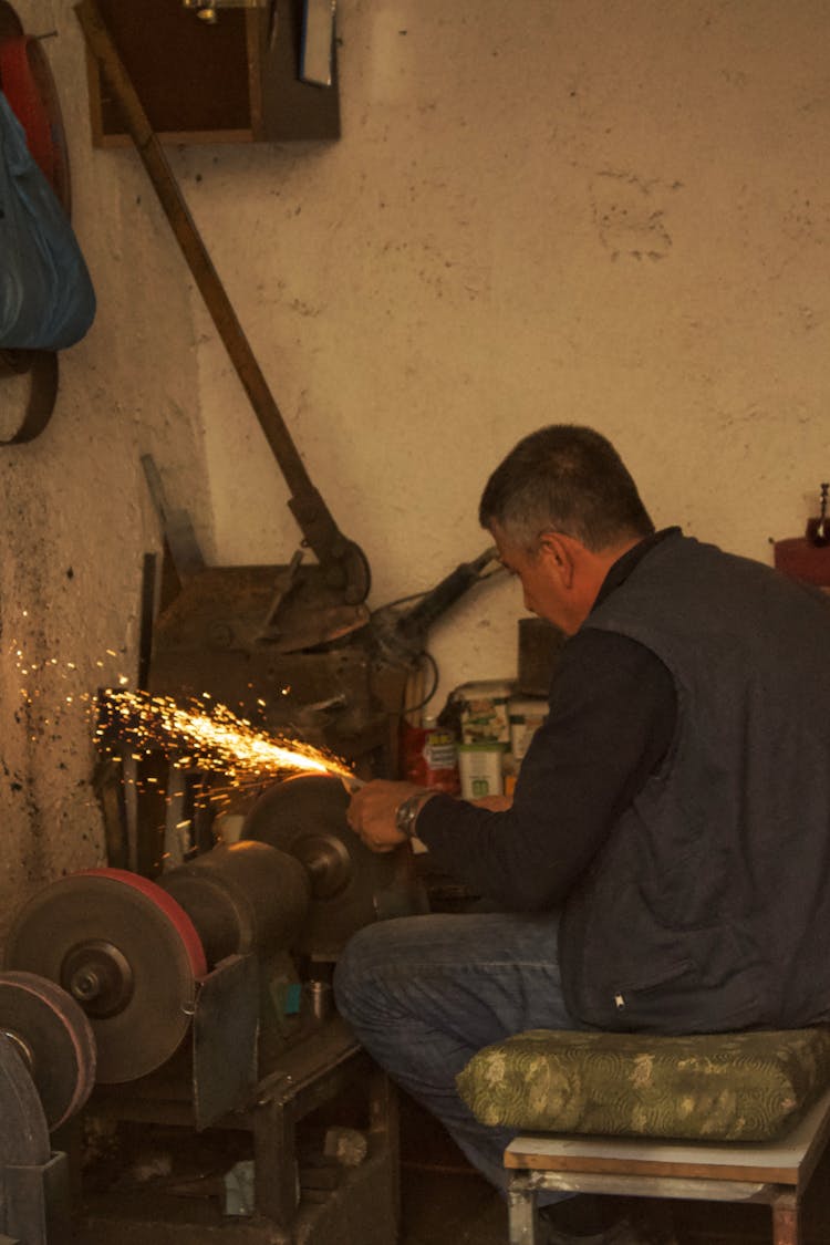 Smith Sitting In Corner In Workshop And Working