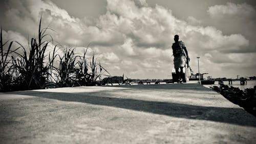 Man on pier b/w