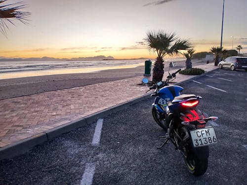 A motorcycle watches the beach sunset