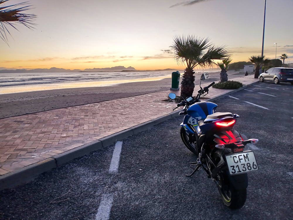 A motorcycle watches the beach sunset