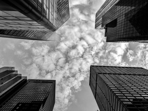Free Low angle shot of New York's modern skyscrapers reaching into a cloudy sky. Stock Photo