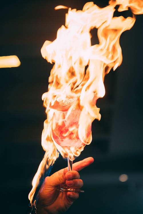 Hand Holding Glass with Burning Fire