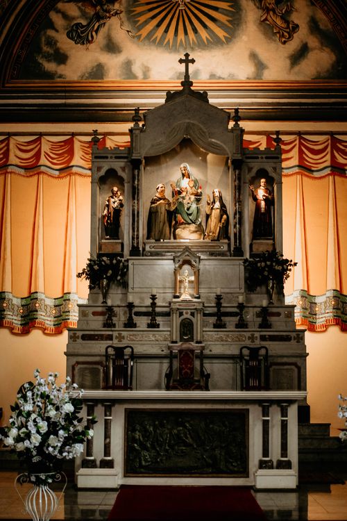 Free An intricately designed church altar featuring religious statues, illuminated warmly. Stock Photo