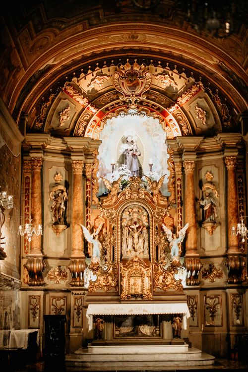 Free Stunning Baroque altar architecture in an ornate Catholic church setting. Indoor vertical shot. Stock Photo