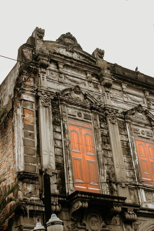 Free Historic neoclassical facade with closed windows, showcasing urban architecture. Stock Photo