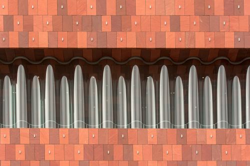 Free Close-up of the wavy, sandstone facade of MAS Museum in Antwerp, Belgium. Stock Photo