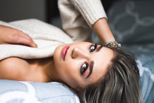 A relaxing portrait of a woman lying in bed, conveying calm and beauty.