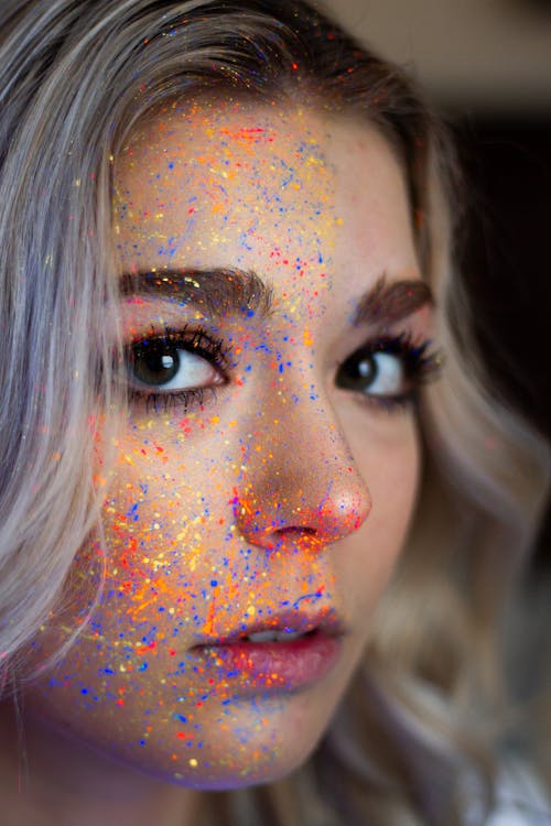 Selective Focus Photo Of Woman With Paint Splash On Her Face