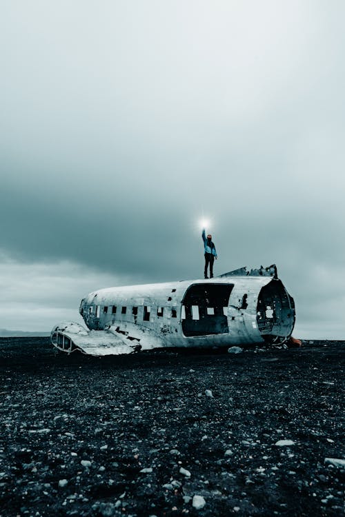 Man Standing on Broken Airplane 