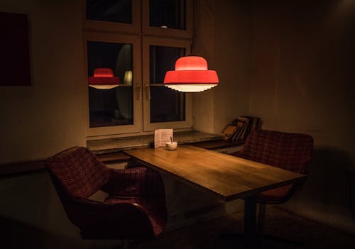 Empty Table and Chairs in a Restaurant in Dim Light