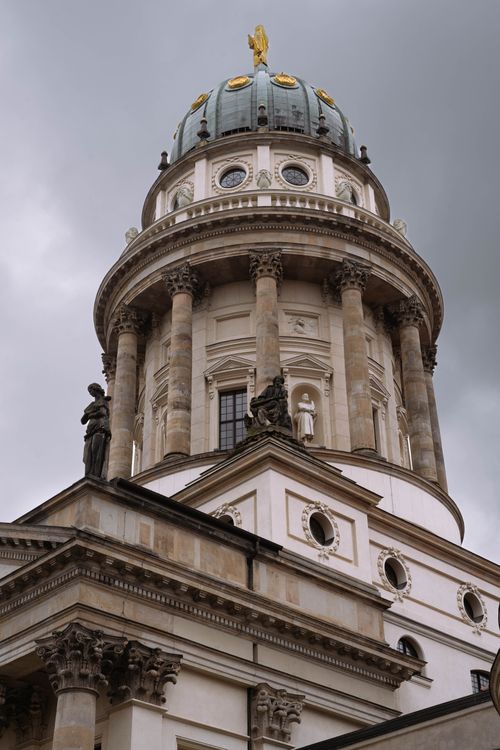 Free Low-angle shot of a classical dome tower in Berlin, featuring ornate architecture and statues under a cloudy sky. Stock Photo